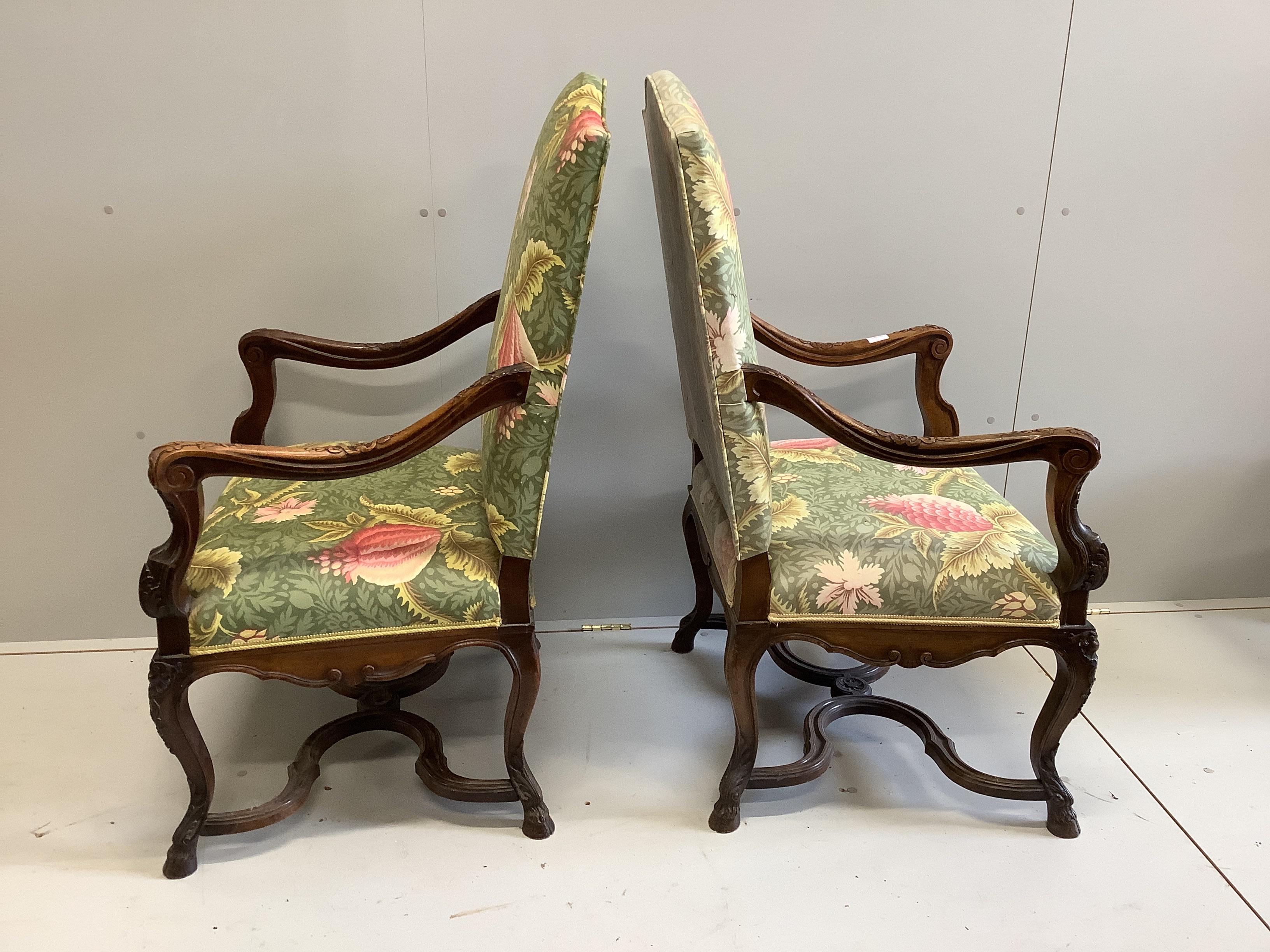 A pair of 18th century style French walnut elbow chairs, width 70cm, depth 60cm, height 116cm